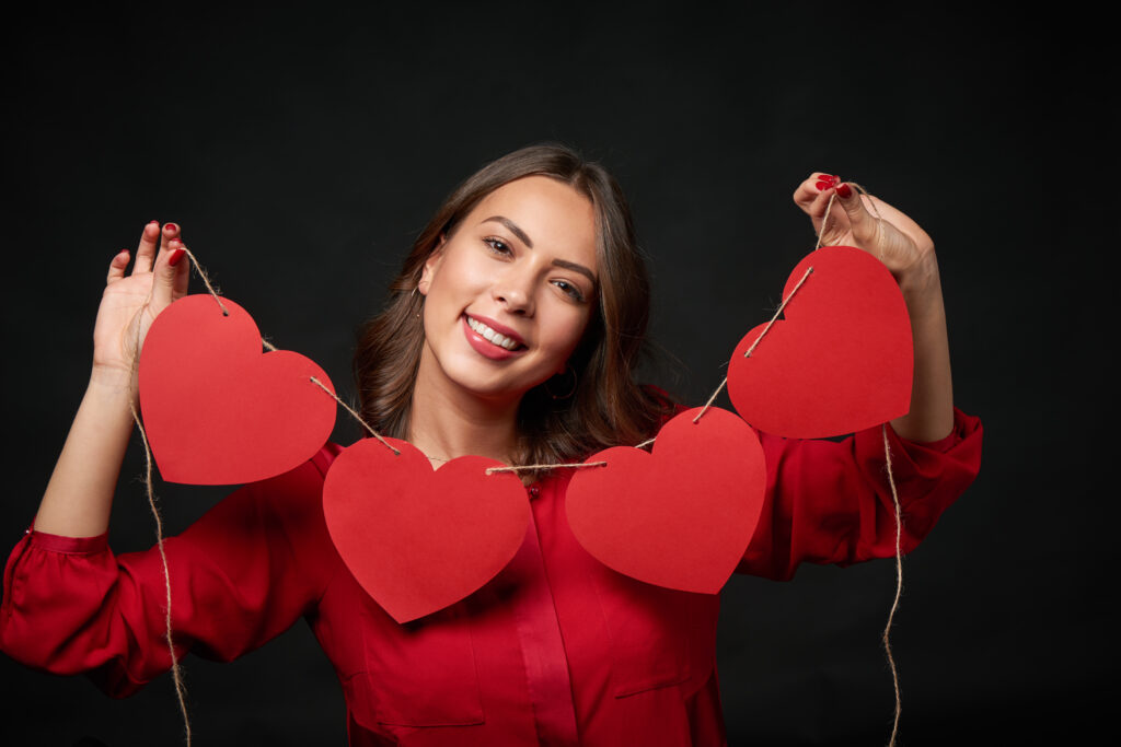 Woman holding thread with four heart shapes